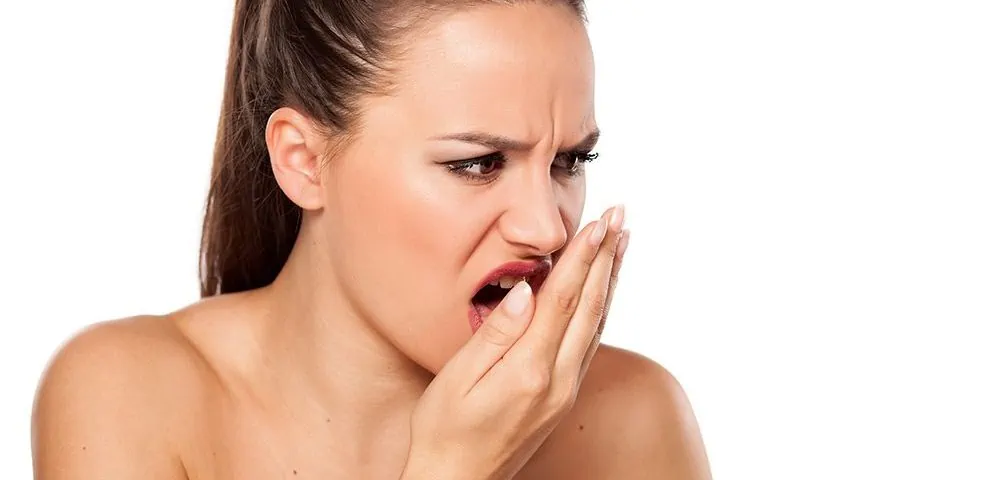 Woman checking for bad breath.